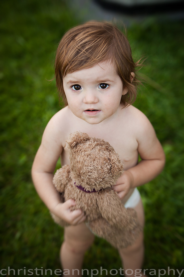 Duluth MN Lifestyle Family Session with a beloved teddy bear, apple tree, apples, sleepy kids, balloons, lawnmower, siblings, diaper, laundry, mom, dad - all outdoors in the back yard of their home.