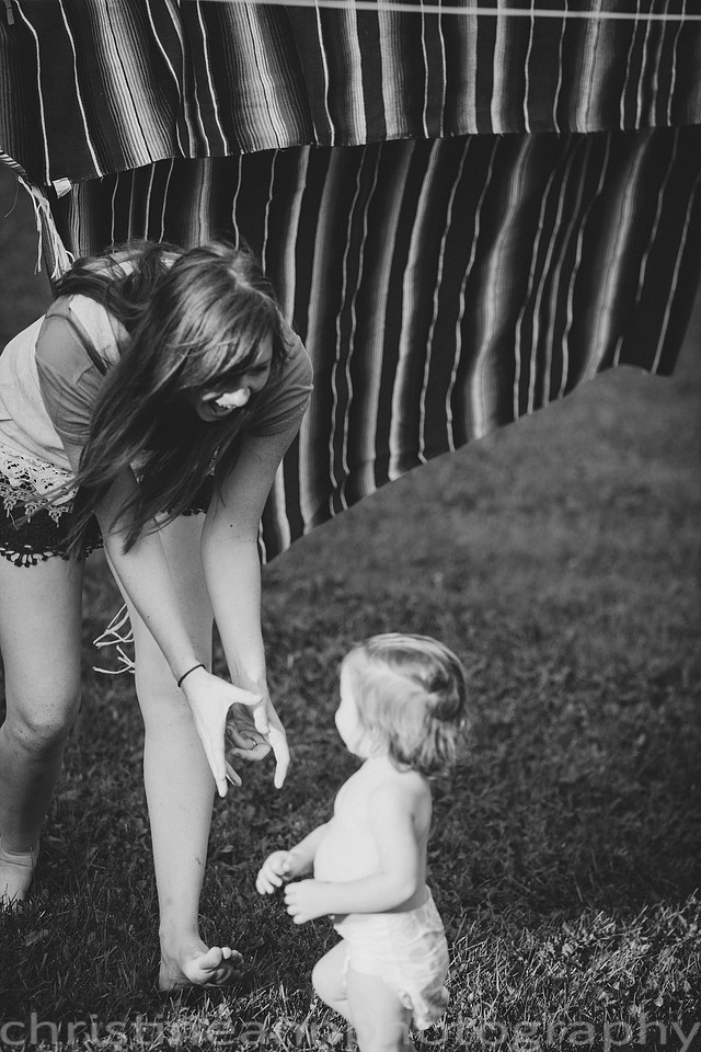 Duluth MN Lifestyle Family Session with a beloved teddy bear, apple tree, apples, sleepy kids, balloons, lawnmower, siblings, diaper, laundry, mom, dad - all outdoors in the back yard of their home.