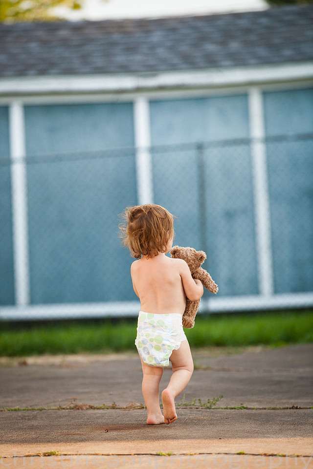 Duluth MN Lifestyle Family Session with a beloved teddy bear, apple tree, apples, sleepy kids, balloons, lawnmower, siblings, diaper, laundry, mom, dad - all outdoors in the back yard of their home.