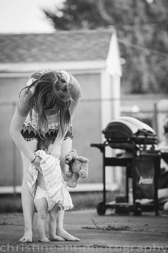 Duluth MN Lifestyle Family Session with a beloved teddy bear, apple tree, apples, sleepy kids, balloons, lawnmower, siblings, diaper, laundry, mom, dad - all outdoors in the back yard of their home.