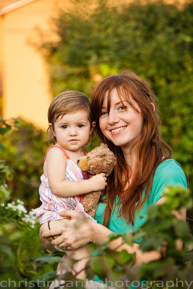 Duluth MN Lifestyle Family Session with a beloved teddy bear, apple tree, apples, sleepy kids, balloons, lawnmower, siblings, diaper, laundry, mom, dad - all outdoors in the back yard of their home.