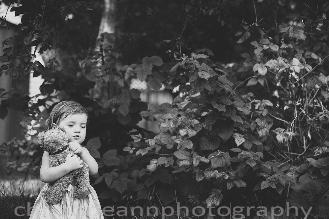 Duluth MN Lifestyle Family Session with a beloved teddy bear, apple tree, apples, sleepy kids, balloons, lawnmower, siblings, diaper, laundry, mom, dad - all outdoors in the back yard of their home.