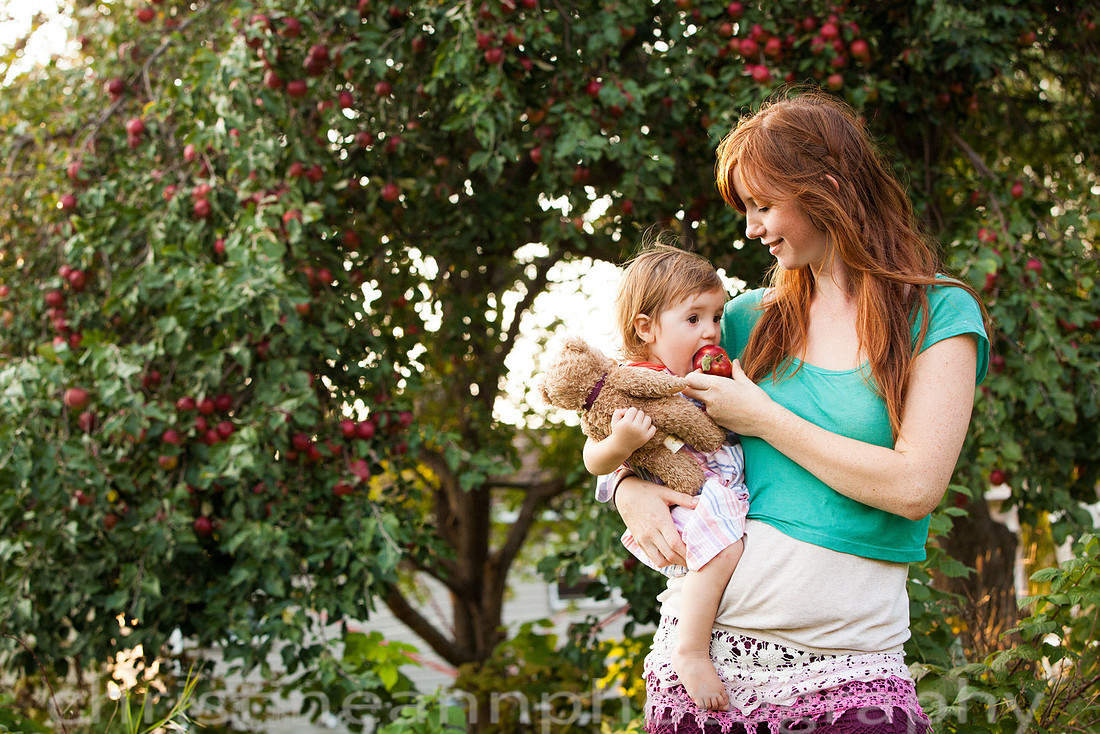 Duluth MN Lifestyle Family Session with a beloved teddy bear, apple tree, apples, sleepy kids, balloons, lawnmower, siblings, diaper, laundry, mom, dad - all outdoors in the back yard of their home.