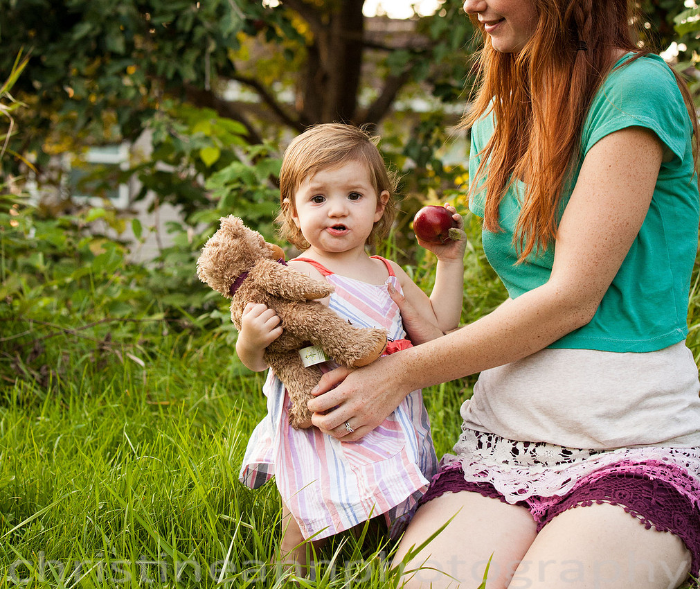 Duluth MN Lifestyle Family Session with a beloved teddy bear, apple tree, apples, sleepy kids, balloons, lawnmower, siblings, diaper, laundry, mom, dad - all outdoors in the back yard of their home.