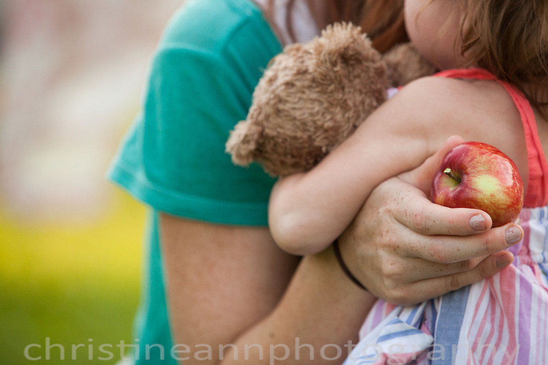 Duluth MN Lifestyle Family Session with a beloved teddy bear, apple tree, apples, sleepy kids, balloons, lawnmower, siblings, diaper, laundry, mom, dad - all outdoors in the back yard of their home.