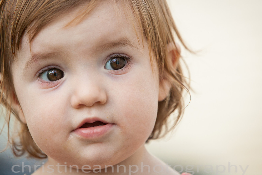 Duluth MN Lifestyle Family Session with a beloved teddy bear, apple tree, apples, sleepy kids, balloons, lawnmower, siblings, diaper, laundry, mom, dad - all outdoors in the back yard of their home.