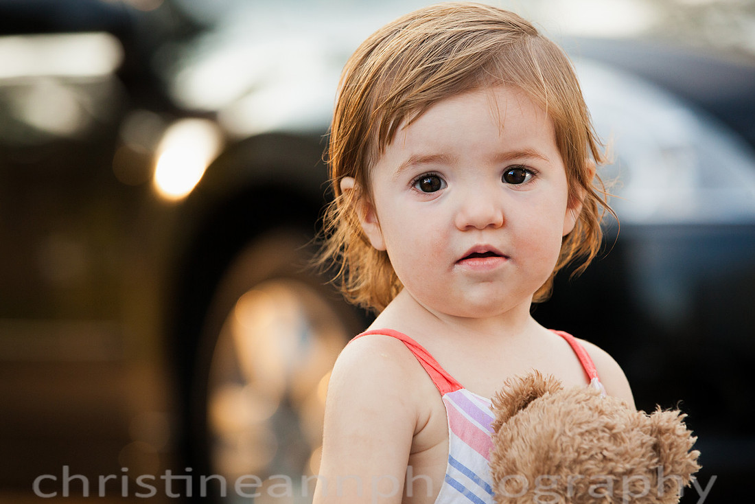 Duluth MN Lifestyle Family Session with a beloved teddy bear, apple tree, apples, sleepy kids, balloons, lawnmower, siblings, diaper, laundry, mom, dad - all outdoors in the back yard of their home.