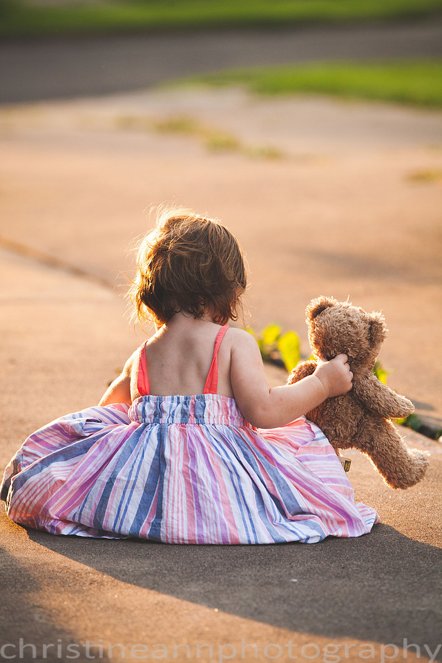 Duluth MN Lifestyle Family Session with a beloved teddy bear, apple tree, apples, sleepy kids, balloons, lawnmower, siblings, diaper, laundry, mom, dad - all outdoors in the back yard of their home.