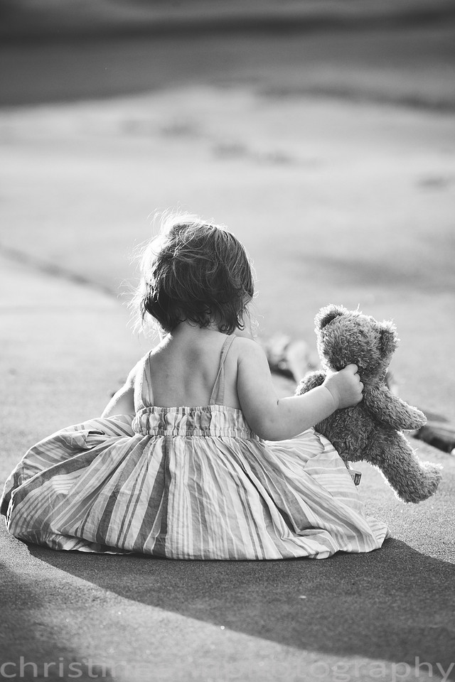 Duluth MN Lifestyle Family Session with a beloved teddy bear, apple tree, apples, sleepy kids, balloons, lawnmower, siblings, diaper, laundry, mom, dad - all outdoors in the back yard of their home.