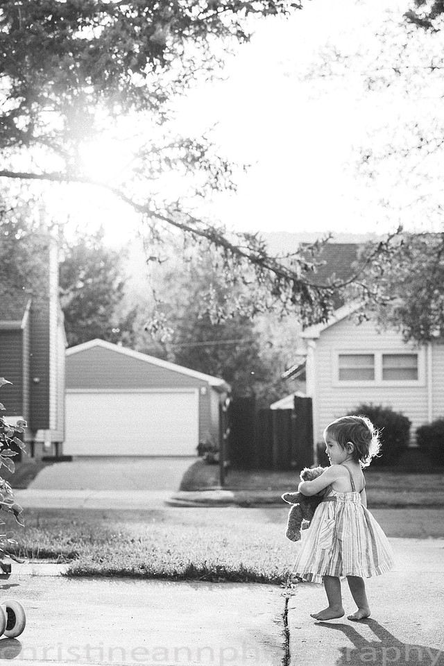 Duluth MN Lifestyle Family Session with a beloved teddy bear, apple tree, apples, sleepy kids, balloons, lawnmower, siblings, diaper, laundry, mom, dad - all outdoors in the back yard of their home.