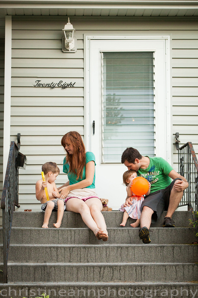Duluth MN Lifestyle Family Session with a beloved teddy bear, apple tree, apples, sleepy kids, balloons, lawnmower, siblings, diaper, laundry, mom, dad - all outdoors in the back yard of their home.