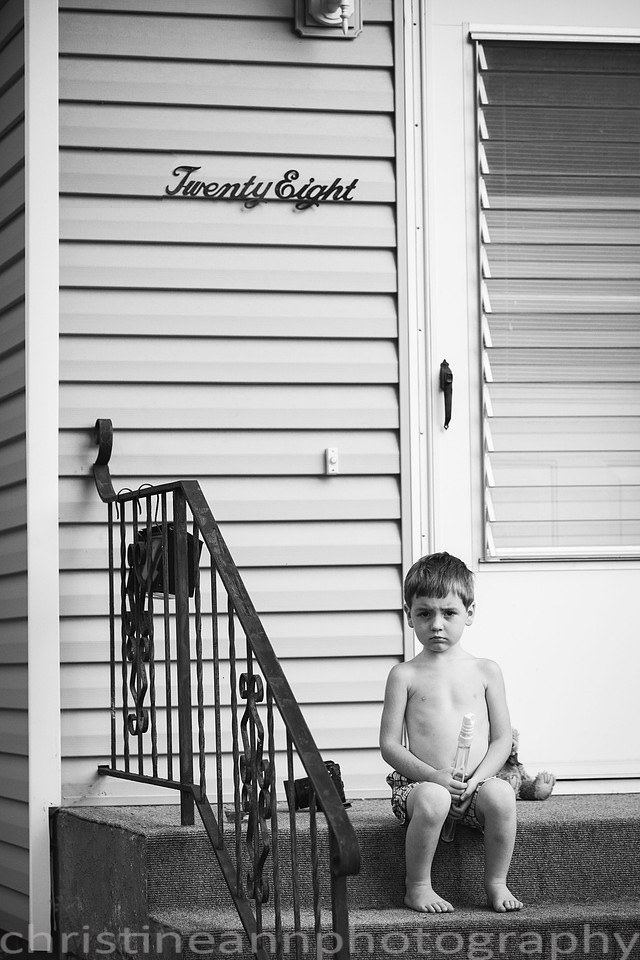 Duluth MN Lifestyle Family Session with a beloved teddy bear, apple tree, apples, sleepy kids, balloons, lawnmower, siblings, diaper, laundry, mom, dad - all outdoors in the back yard of their home.