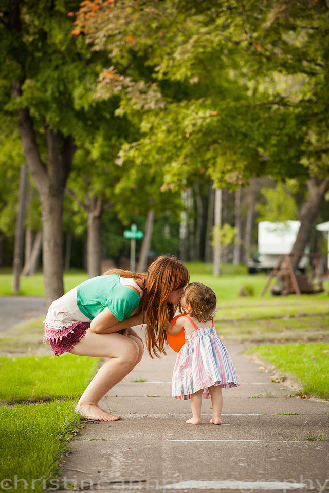 Duluth MN Lifestyle Family Session with a beloved teddy bear, apple tree, apples, sleepy kids, balloons, lawnmower, siblings, diaper, laundry, mom, dad - all outdoors in the back yard of their home.