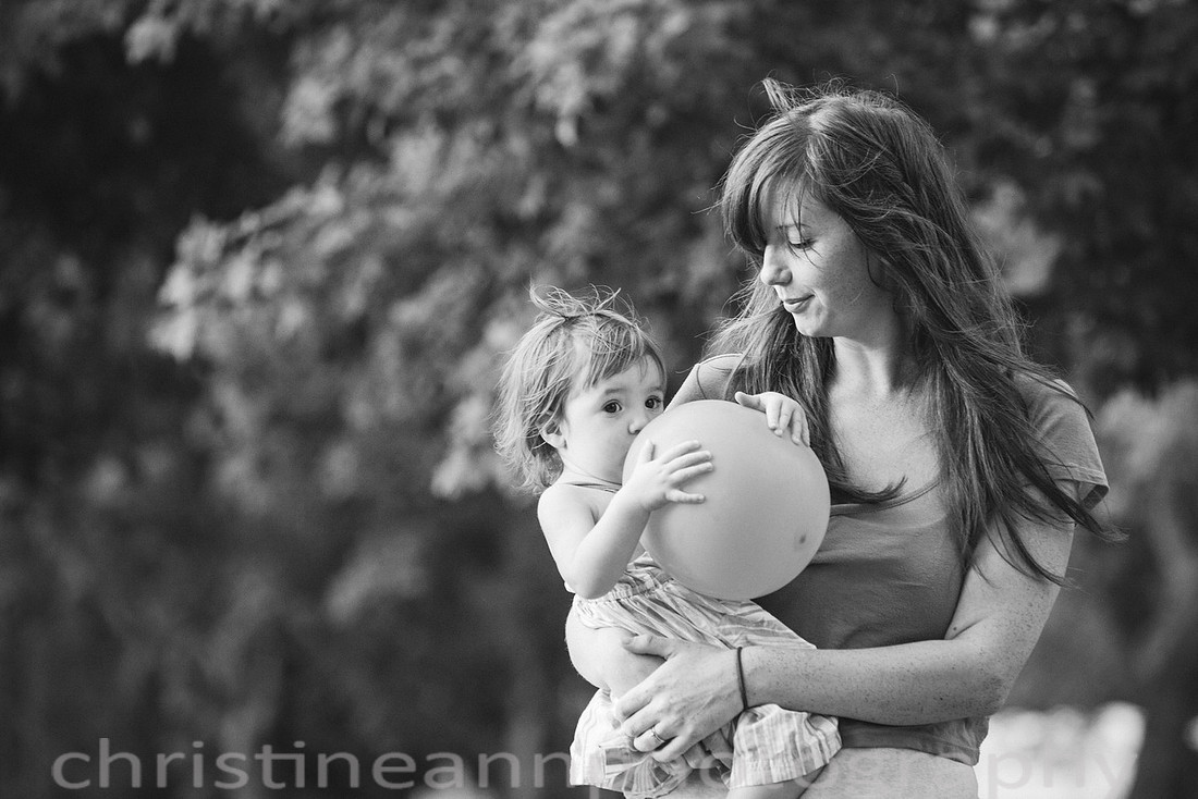 Duluth MN Lifestyle Family Session with a beloved teddy bear, apple tree, apples, sleepy kids, balloons, lawnmower, siblings, diaper, laundry, mom, dad - all outdoors in the back yard of their home.