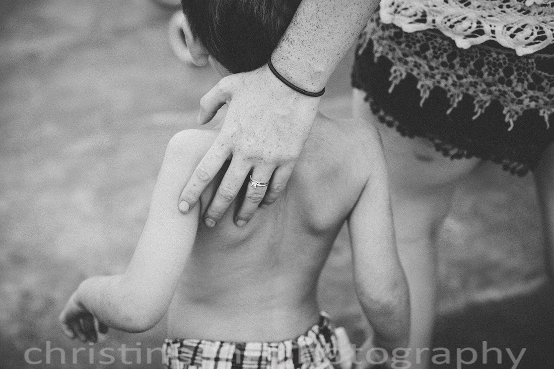Duluth MN Lifestyle Family Session with a beloved teddy bear, apple tree, apples, sleepy kids, balloons, lawnmower, siblings, diaper, laundry, mom, dad - all outdoors in the back yard of their home.