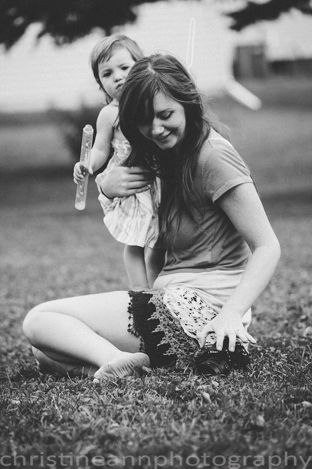 Duluth MN Lifestyle Family Session with a beloved teddy bear, apple tree, apples, sleepy kids, balloons, lawnmower, siblings, diaper, laundry, mom, dad - all outdoors in the back yard of their home.
